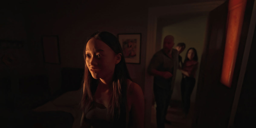 Chloe (Callina Liang) looking just a bit away from the camera's POV. Chris (Chris Sullivan), Rebekah (Lucy Liu) and Tyler (Eddy Maday) are in the background out-of-focus.